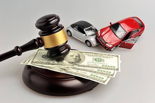 gavel on money near toy cars