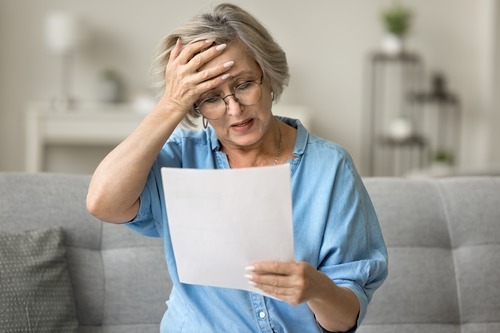 Older Woman Looking at Medical Bills