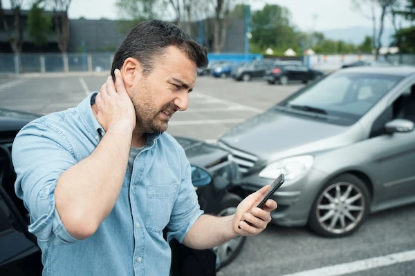 A man with neck pain needs a doctor after a car accident.